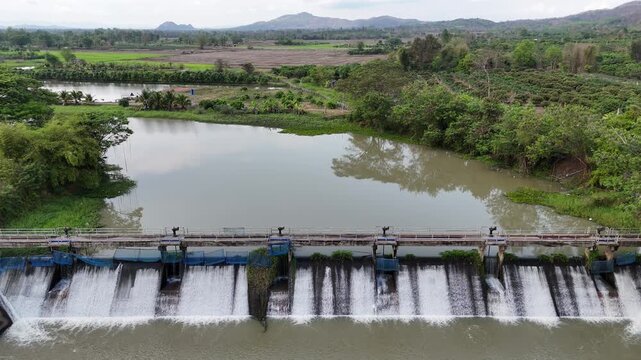 Aerial view of small spillway in Pa Daet district in Chiang Rai province of Thailand. Spillway, passage for surplus water over or around a dam when the reservoir itself is full.