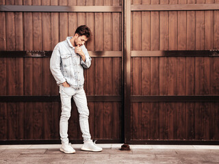Portrait of handsome confident stylish hipster lambersexual model. Sexy man dressed in jeans...