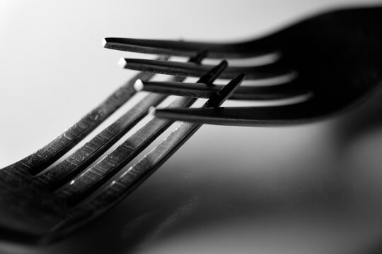 A fork with four prongs is bent at the top