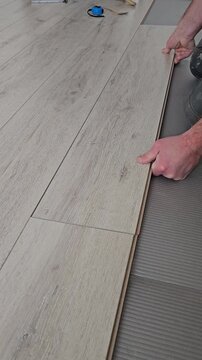 Installing wooden floor with interlocking pieces in a home renovation project