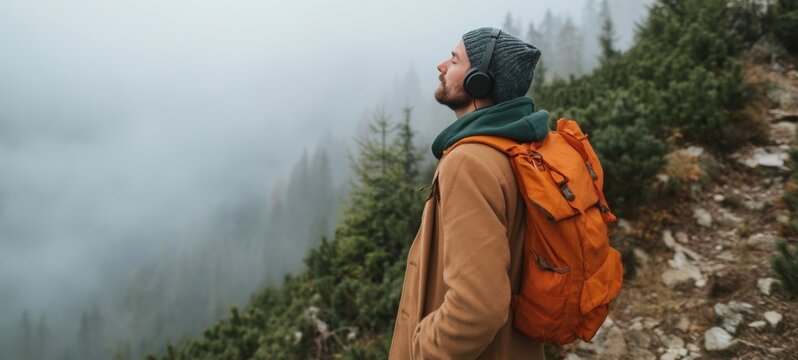 Outdoor Adventure - Hiker with Backpack on Mountain Trail