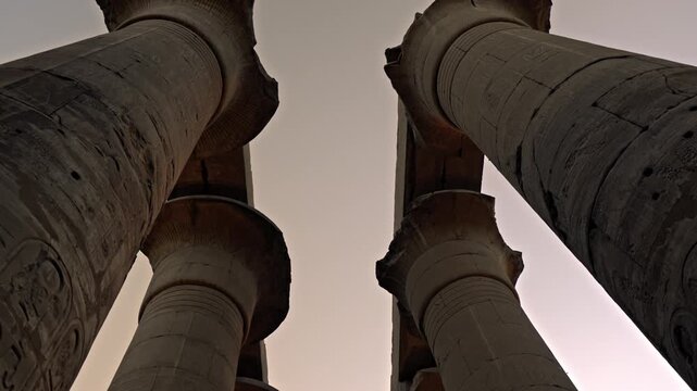 The Great Colonnade at Luxor Temple in Luxor, Egypt, during the final moments of sunset. The camera moves beneath two rows of seven soaring columns, each reaching 16 meters height.