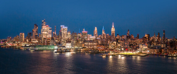 Fototapeta premium NYC cityscape. New York waterfront. New York aerial view of Manhattan skyscrapers. New York City skyscrapers panoramic landscape. NYC panoramic view of Lower Manhattan skyline. New York City at night.