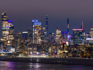 Fototapeta premium NYC Manhattan skyline with famous towers. New York City night panorama. New York glowing skyscrapers. Downtown Manhattan skyline.