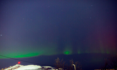 Fototapeta premium Aurora borealis, polar lights with Milky Way stars.