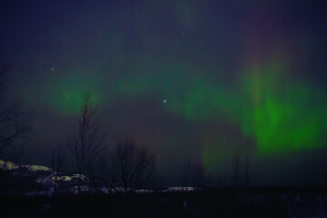 Fototapeta premium Aurora borealis, polar lights with Milky Way stars.