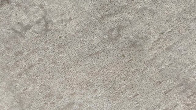 Aerial view of cracked land surface, emphasizing desertification, extreme heat exposure, and the consequences of insufficient rainfall on natural ecosystems.
