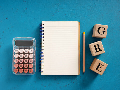 Preparing for GRE exam with calculator, notebook and pencil