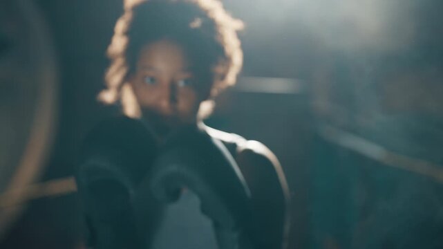 Black woman fighting, portrait of active sportswoman striking by arm to camera. Professional sport and fitness for stay healthy and slender, combat sports and self-defense class for ladies, be strong