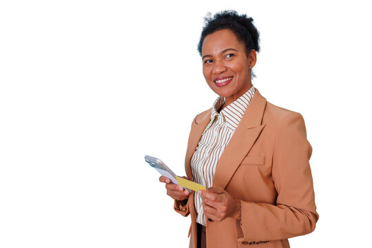 Black businesswoman smiling, holding credit card and smartphone, engaging in online shopping and secure e-payment