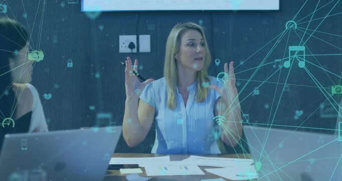 Male and female coworkers using laptops and working late in an office
