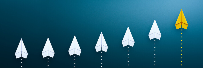 Success in business growth concept. Yellow paper plane on blue background