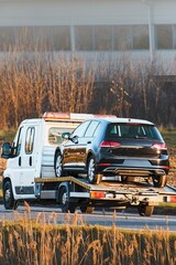 Highway towing service with yellow flatbed © AlexGo
