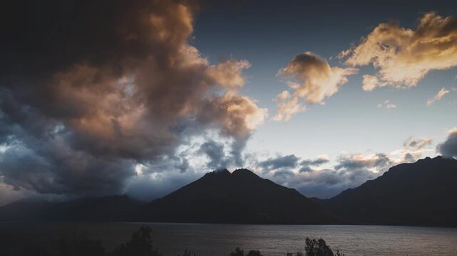 Timelapse of Dark Storm Clouds with Golden Backlight Over Lake Wakatipu and Cecil Peak New Zealand