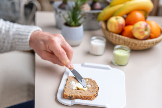 butter being spread bread bun knife one-handed, non-slip adaptive cutting board, morning breakfast for people with severe physical impairments, occupational therapy, specialized Assistive technology