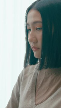 Vertical Screen : Young Asia female freelance typing write prompt AI bot IT app program nomad, video game, terminal with coding language, user interface, designer, big data center on desktop computer.