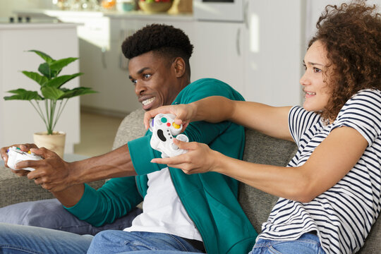 couple jostling eachother while playing computer game