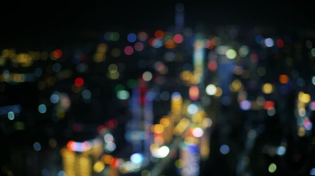 Defocused view of business district skyscrapers at night