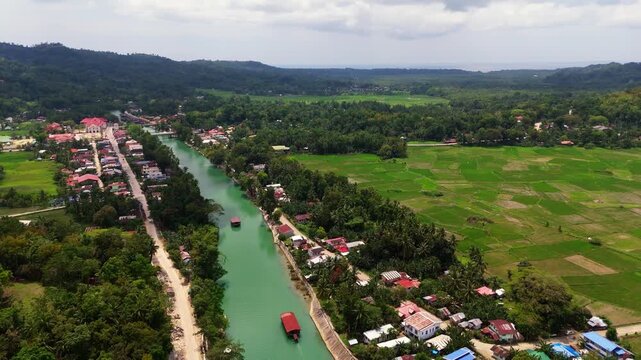 erial view of the emerald Loboc River cutting through the thick tropical rainforests of Bohol, Philippines