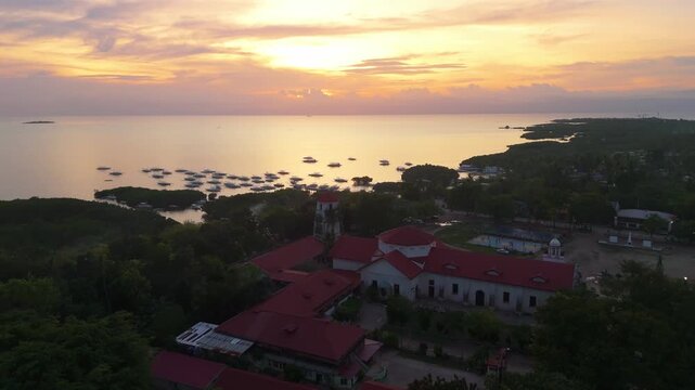 Aerial view of the historic St. Augustine Parish Church and the stone watchtower in Panglao, Bohol
