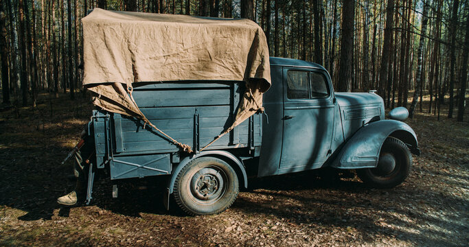 Vintage German military truck parked in forest during World War II