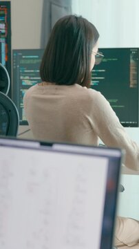 Vertical Screen : Young adult Asia female freelance eyeglasses typing write prompt AI bot app smart program nomad, video game, terminal coding, user interface, designer, big data center on computer.