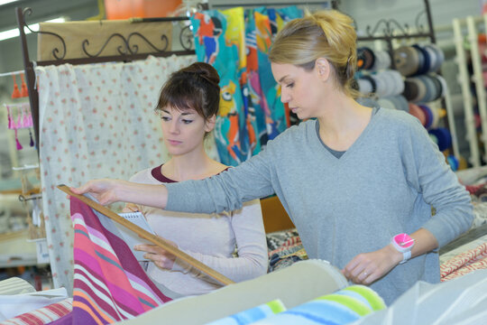 two women shopping together in fabric shop