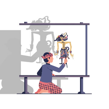 Indonesian boy performing traditional Wayang Kulit shadow puppet show with illuminated screen