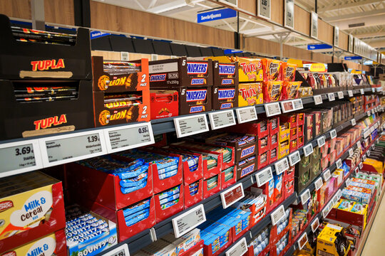 RIGA, LATVIA. 12th March 2026. Assorted chocolate bars and snacks on supermarket display shelves