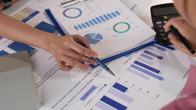 Financial analysts collaborating on business data report