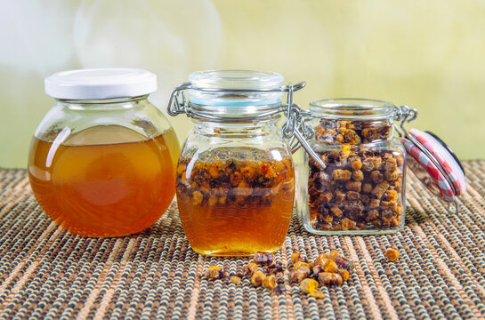 Alternative medicine mixture made with honey and bee bread ( fermented flower and plant pollen by honey bees) inside small glass jar indoors.