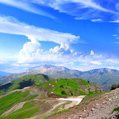 Naklejka premium Aerial view of picturesque scenery in Western Tien Shan Mountains, Uzbekistan. A bird's-eye view of the enchanting mountain landscape. Vertical photo - landscape of Chimgan mountains, Tashkent region