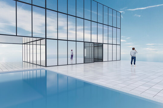 Modern glass building with terrace and pool overlooking the ocean