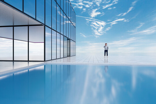Modern glass building with large windows and terrace by the ocean