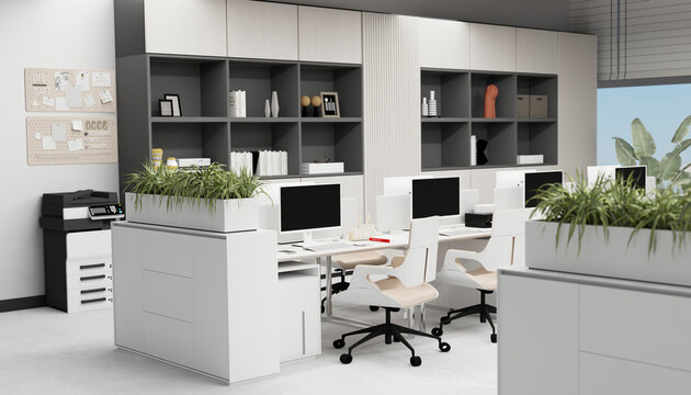 Modern open office with computer workstations and indoor plants
