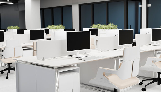 Modern open office with computer workstations and indoor plants