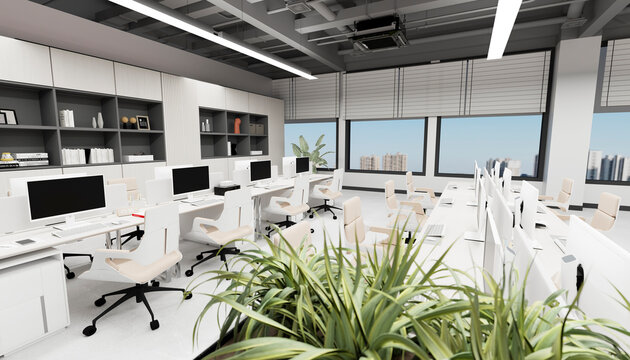Modern open office with computer workstations and indoor plant