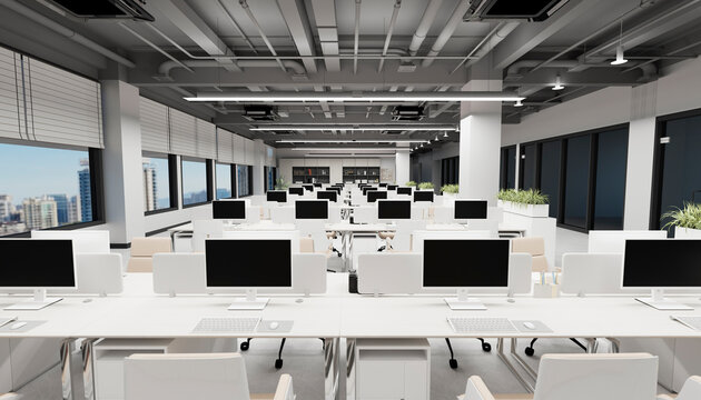 Modern open office with computer workstations and indoor plants
