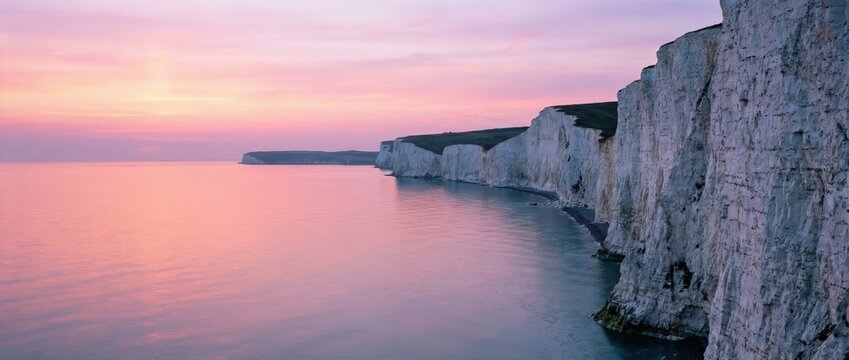 Sunrise over the white cliffs of dover scenic landscape photography coastal environment serene viewpoint nature's beauty and tranquility