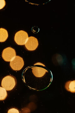 Abstract colorful bubbles and bokeh light in liquid macro close up