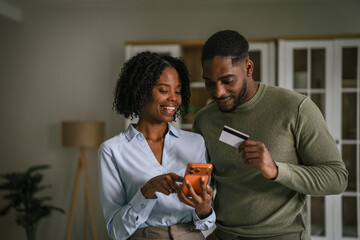 African american couple shopping online with credit card