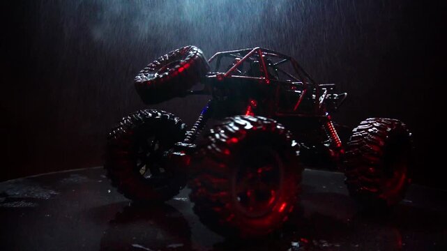off-road toy cars turn with big tires art creative in water splashes 360 degree rotation on dark background with red backlight
