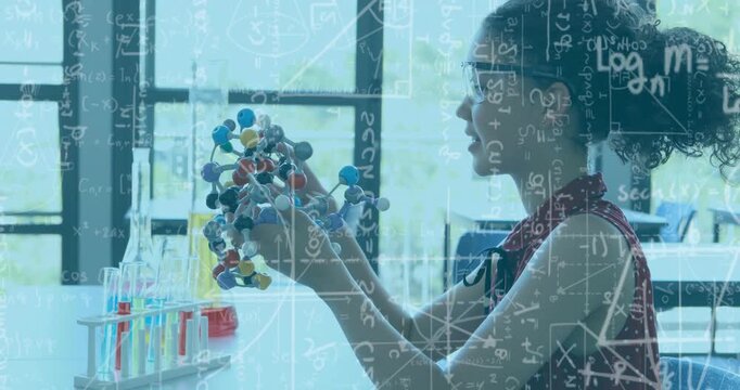 Teen student lifting and rotating molecular model at lab table, studying bonds with formula overlay