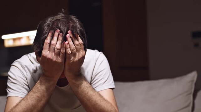 Failure and disappointment, low key portrait of mature adult male sulking, 4K