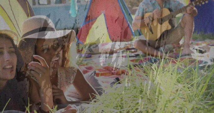 Leisure two women lying and pointing after seeing motion in grass, film overlay aging frame, guitar