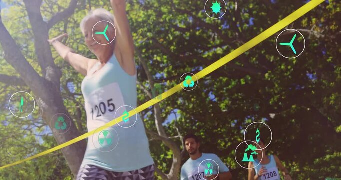 Senior woman running toward yellow tape breaking tape, green icons hovering, fitness duo jogging