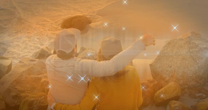 Left person raising arm, drawing right person close, sharing ocean while travel sparkles overlaying