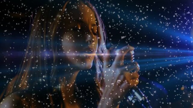 Female singer singing into vintage mic on dark stage, blue lens flare activating sparkle overlay