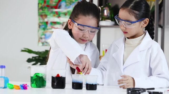 Two Asian Girls in Lab Coats Conducting Science Experiments with Beakers