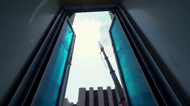 Mobile Crane Working Seen Through Window